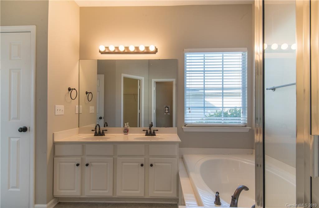 11712 Kennon Ridge Lane Huntersville, NC 28078 - Photo 21 of 31 a bathroom with a sink a vanity and a mirror