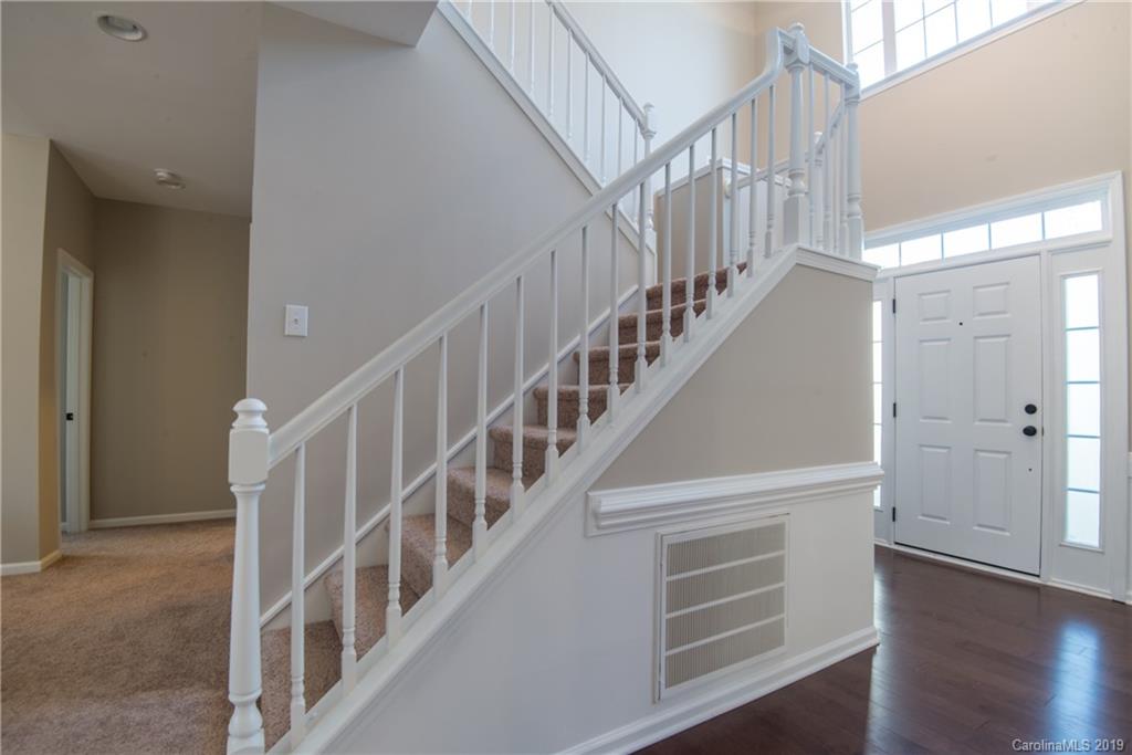 11712 Kennon Ridge Lane Huntersville, NC 28078 - Photo 22 of 31 a view of staircase with wooden floor and white walls