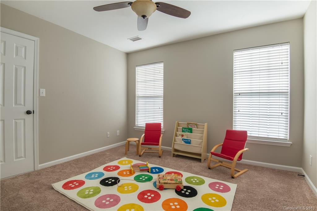 11712 Kennon Ridge Lane Huntersville, NC 28078 - Photo 26 of 31 a bedroom with a bed and a chair