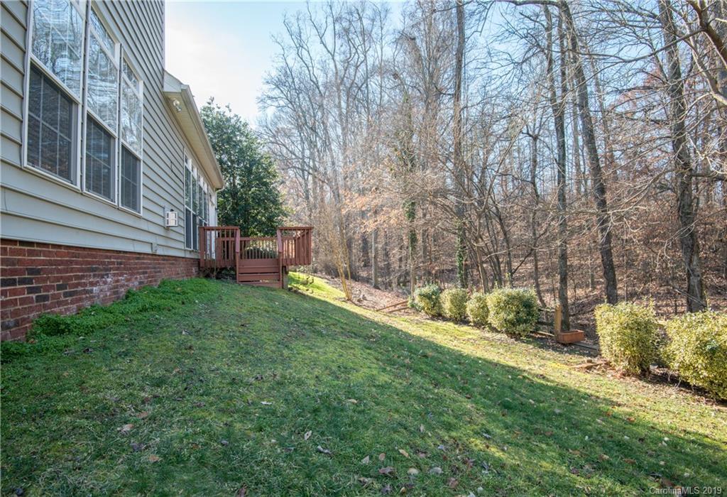 11712 Kennon Ridge Lane Huntersville, NC 28078 - Photo 30 of 31 a view of a backyard with table and chairs and wooden fence