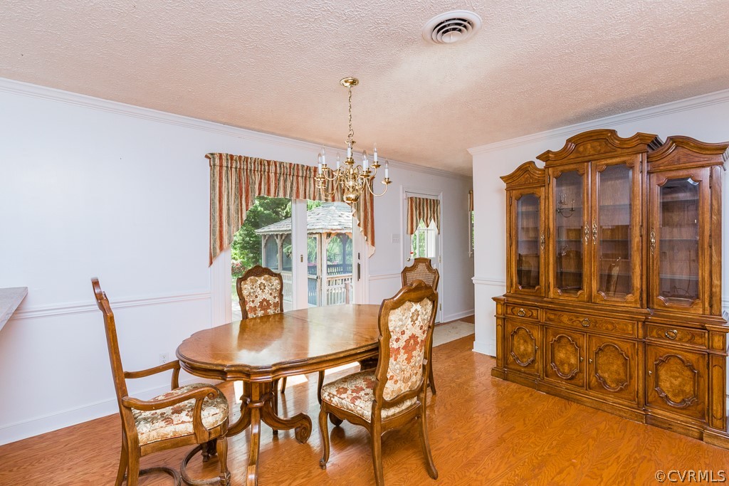 10801 Genito Road Chesterfield, VA 23832 - Photo 12 of 46 a view of a dining room with furniture and chandelier