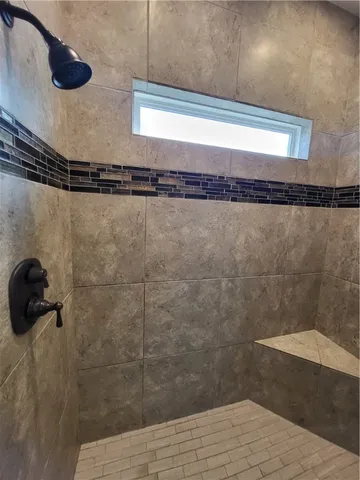 a bathroom with a bathtub and a window