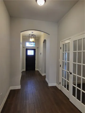 wooden floor in a hall with a window
