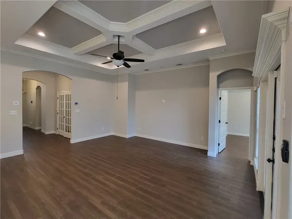 a view of an empty room and wooden floor