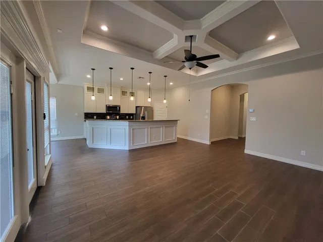 a view of a kitchen with a sink and a refrigerator