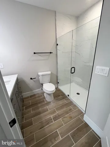 a bathroom with a toilet and a shower