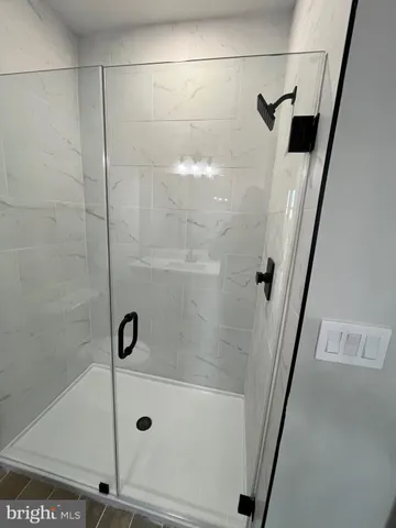 a bathroom with a glass shower door