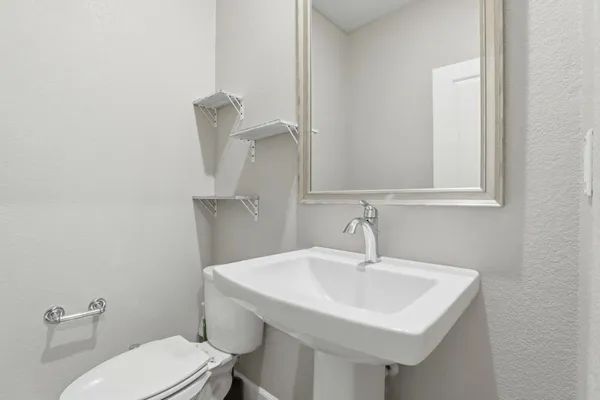 a bathroom with a granite countertop sink mirror and double