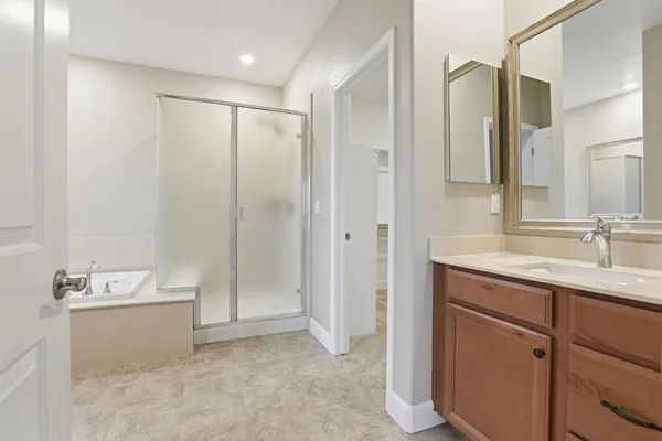 a bathroom with a tub sink and mirror