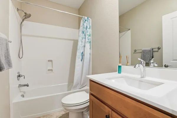 a bathroom with a shower sink and mirror