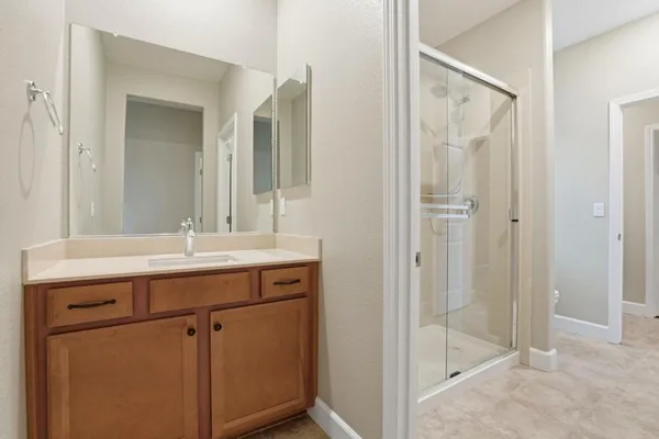 a bathroom with a glass shower door