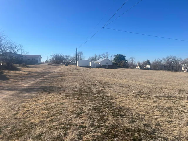 a view of a field with an ocean