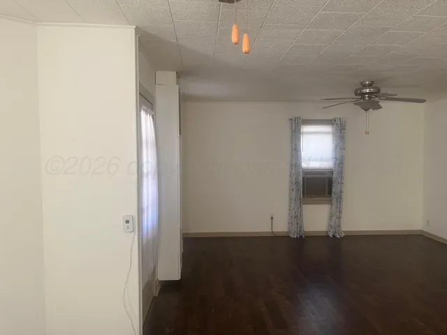 an empty room with wooden floor