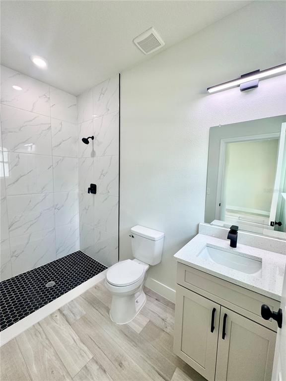 1690 Hamilton Avenue Southwest Palm Bay, FL 32908 - Photo 12 of 56 a bathroom with a sink a toilet a shower and a mirror