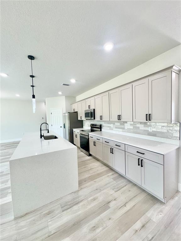 1690 Hamilton Avenue Southwest Palm Bay, FL 32908 - Photo 17 of 56 a large white kitchen with cabinets and sink
