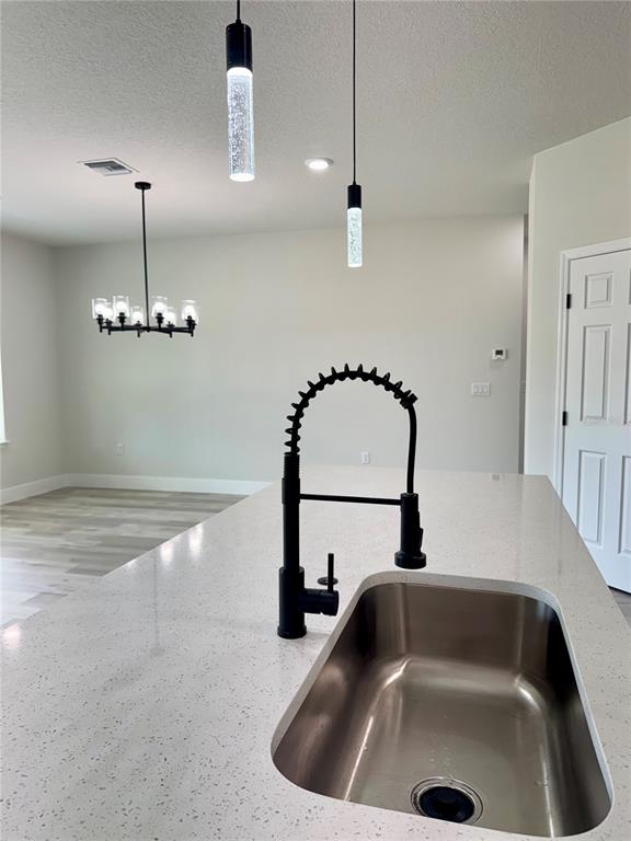 1690 Hamilton Avenue Southwest Palm Bay, FL 32908 - Photo 26 of 56 a kitchen with a sink and chandelier