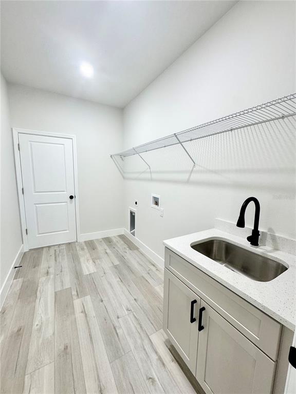 1690 Hamilton Avenue Southwest Palm Bay, FL 32908 - Photo 36 of 56 a view of a kitchen sink and dishwasher with wooden floor