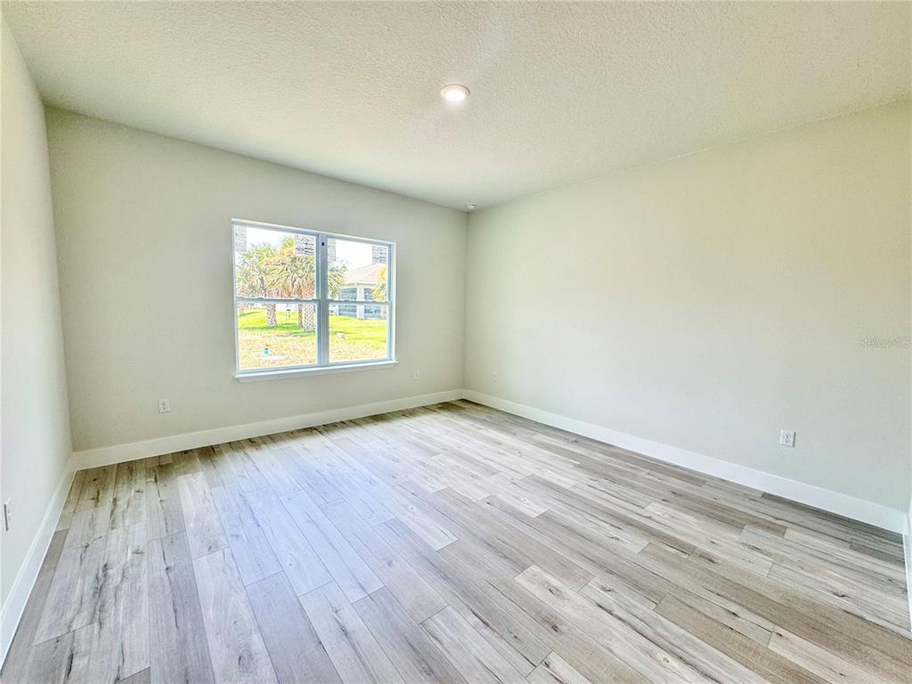 1690 Hamilton Avenue Southwest Palm Bay, FL 32908 - Photo 37 of 56 an empty room with wooden floor and windows