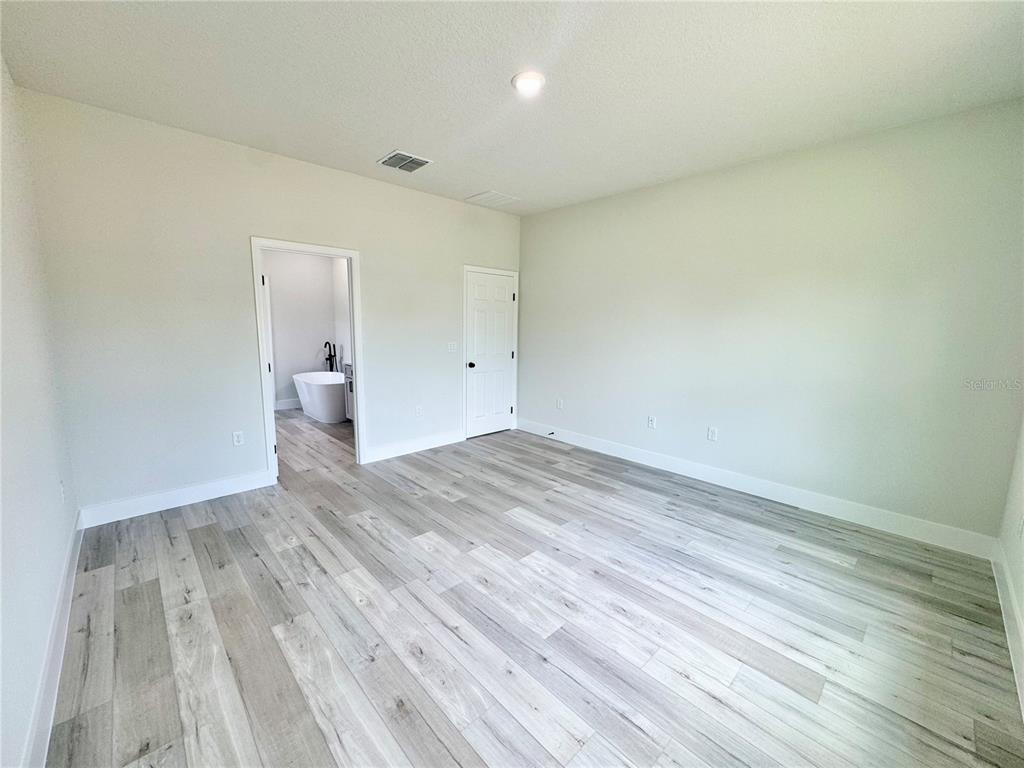 1690 Hamilton Avenue Southwest Palm Bay, FL 32908 - Photo 38 of 56 a view of empty room with wooden floor