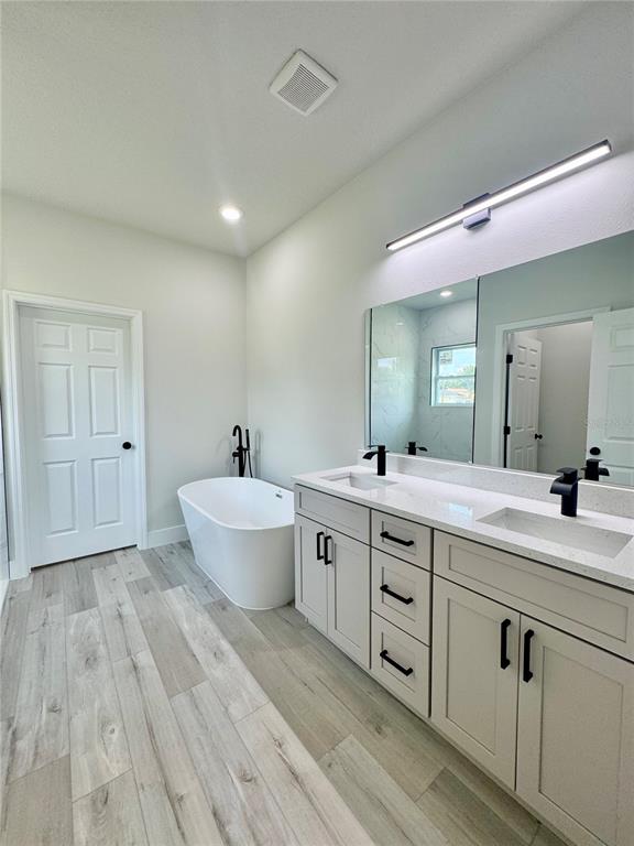1690 Hamilton Avenue Southwest Palm Bay, FL 32908 - Photo 39 of 56 a spacious bathroom with a double vanity sink and a mirror
