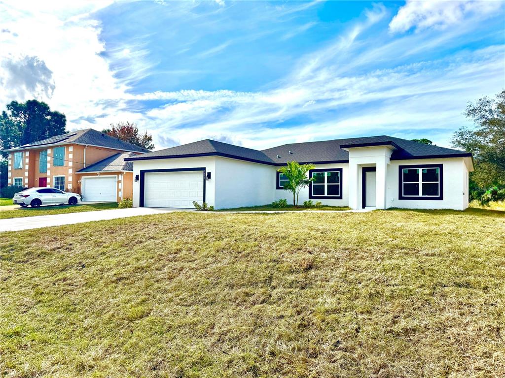 1690 Hamilton Avenue Southwest Palm Bay, FL 32908 - Photo 4 of 56 a front view of a house with a garden