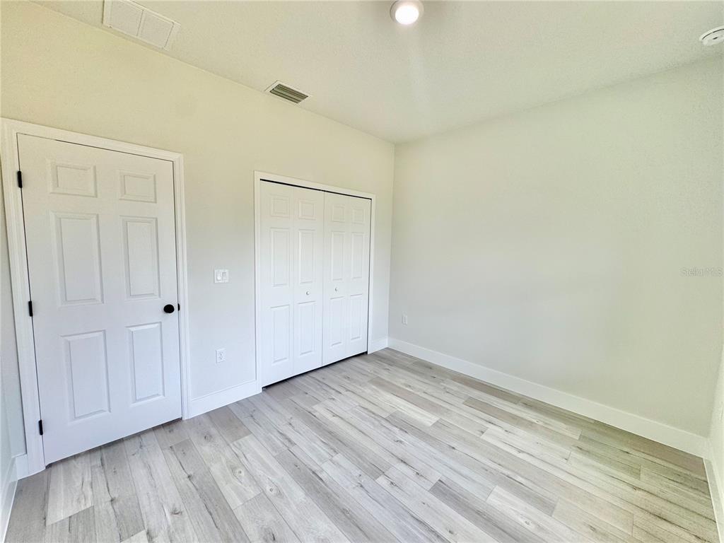 1690 Hamilton Avenue Southwest Palm Bay, FL 32908 - Photo 50 of 56 a view of an empty room and wooden floor