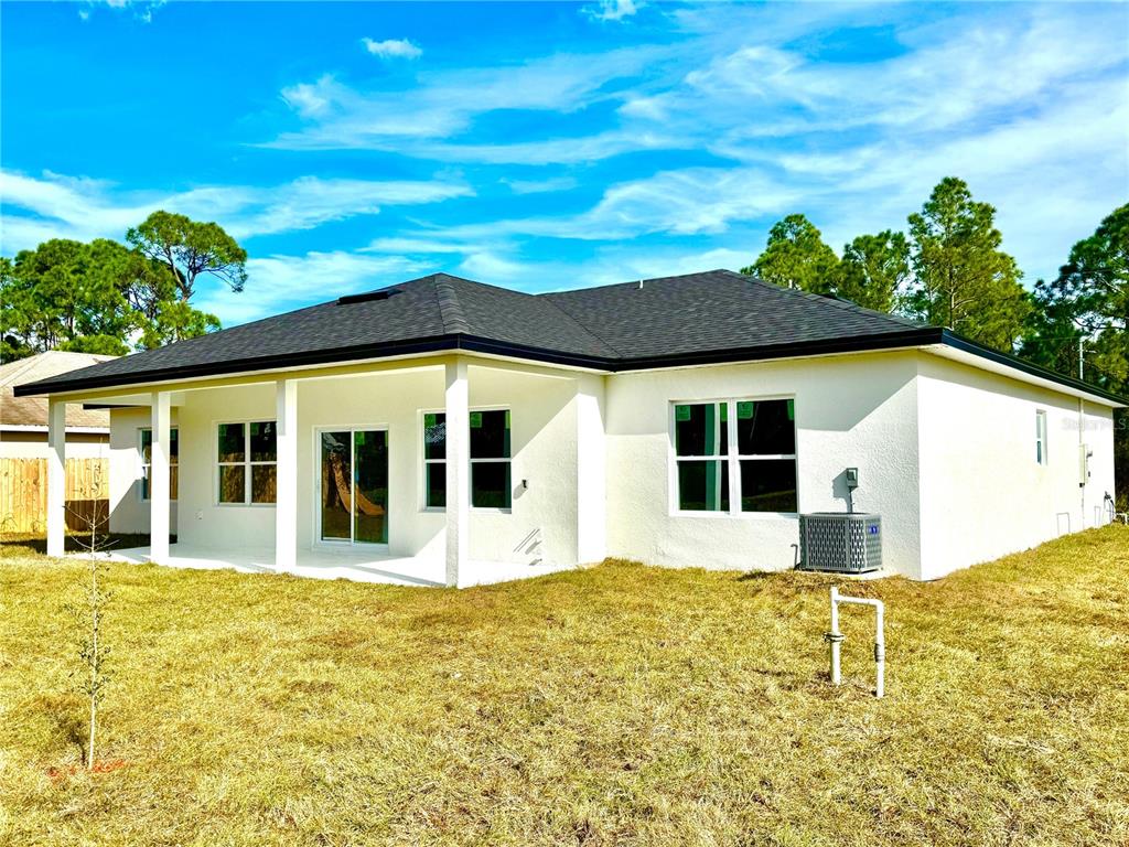 1690 Hamilton Avenue Southwest Palm Bay, FL 32908 - Photo 5 of 56 a front view of a house with a yard