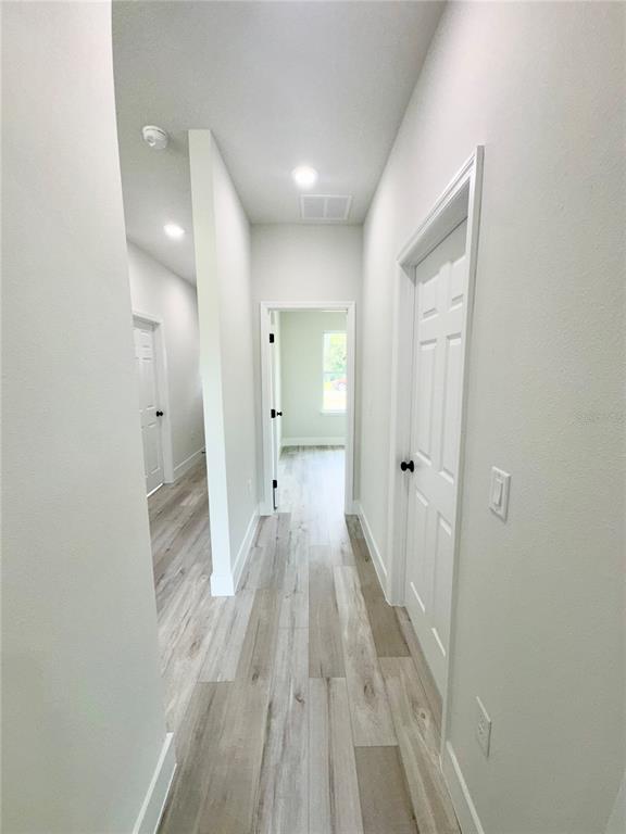 1690 Hamilton Avenue Southwest Palm Bay, FL 32908 - Photo 52 of 56 a view of a room with wooden floor and a hallway