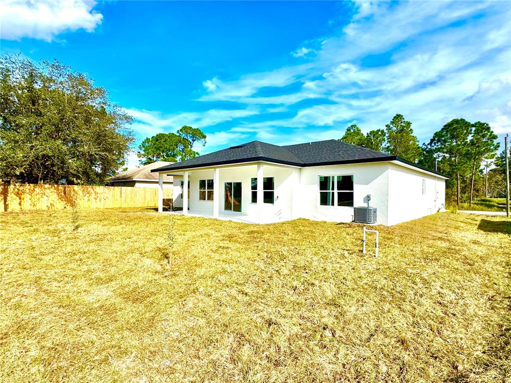 1690 Hamilton Avenue Southwest Palm Bay, FL 32908 - Photo 6 of 56 a view of a house with a backyard
