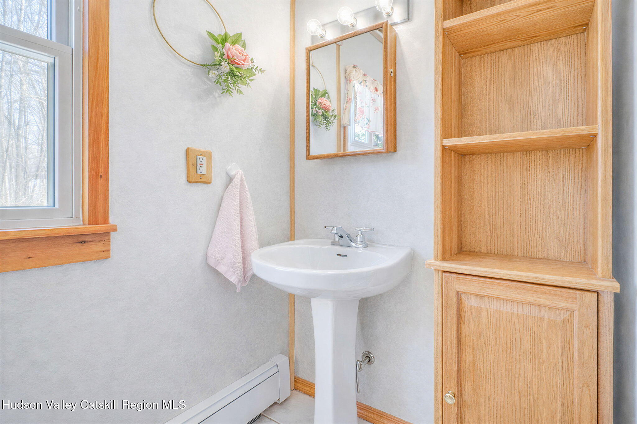 189 Yeagerville Road Napanoch, NY 12458 - Photo 22 of 38 a bathroom with a sink a mirror and a window