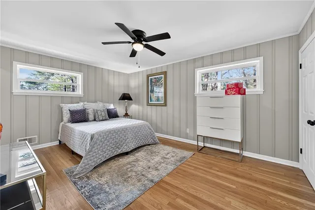 a bedroom with a large bed and a chandelier