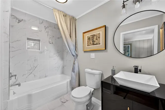 a bathroom with a toilet a sink and a mirror