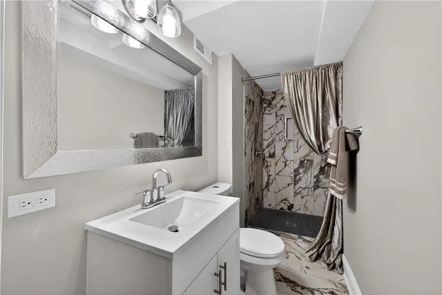 a bathroom with a sink toilet and shower