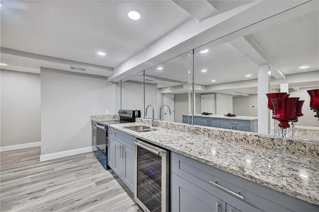 a kitchen with stainless steel appliances granite countertop a sink and a refrigerator