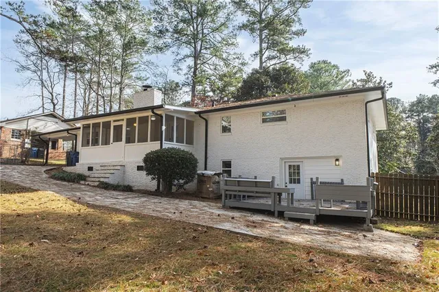 a backyard of a house with barbeque oven and outdoor seating