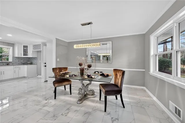 a view of a dining room with furniture and window