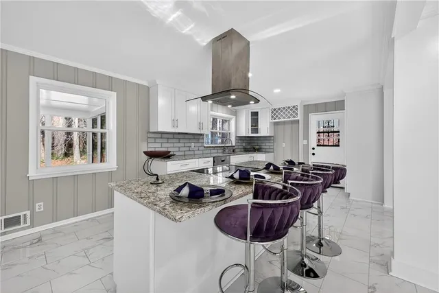 a kitchen with stainless steel appliances granite countertop a stove a sink and a microwave