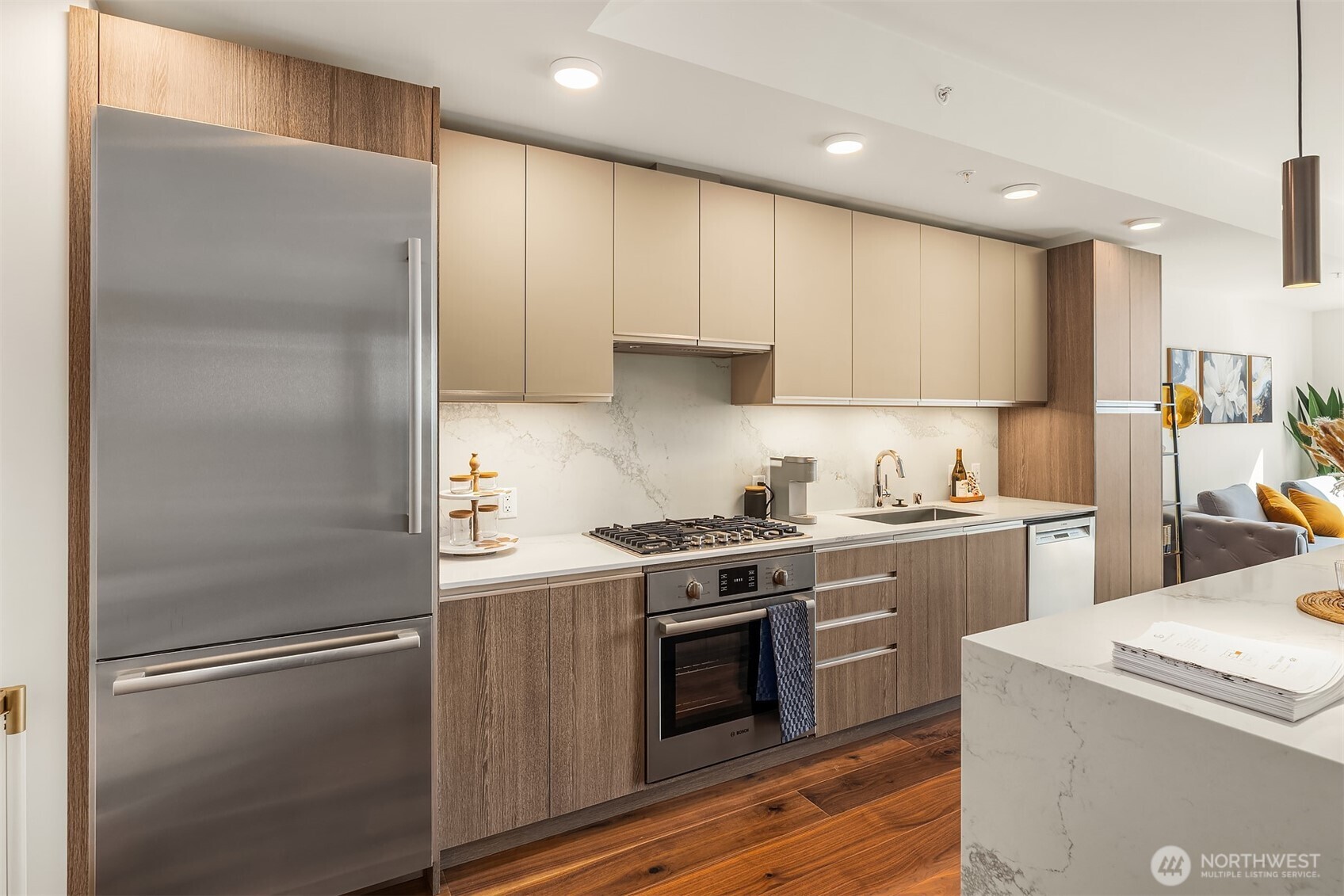 800 Columbia Street, Unit 2307 Seattle, WA 98104 - Photo 7 of 40 a kitchen with a refrigerator stove and wooden floor