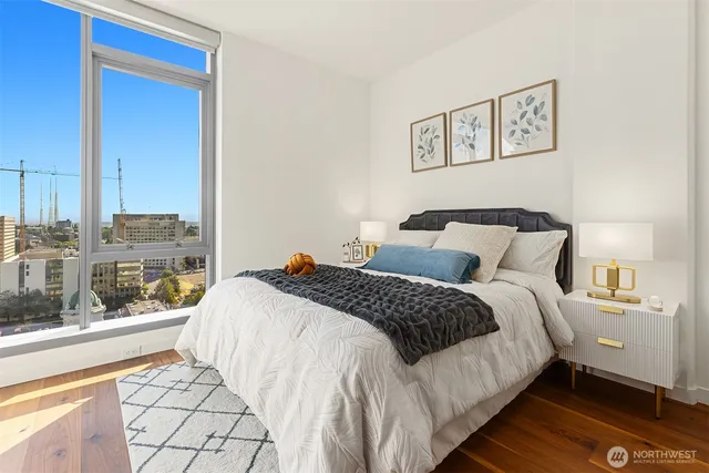 a bedroom with a bed and a large window
