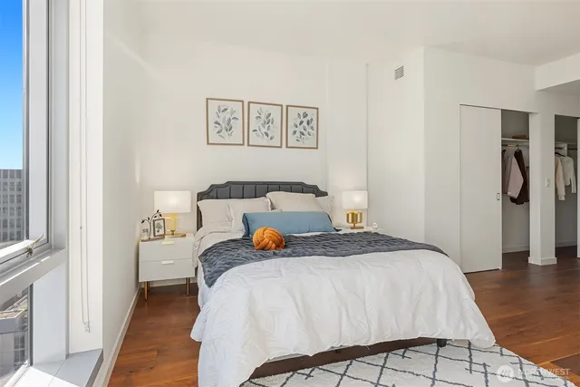 a bedroom with a bed and wooden floor