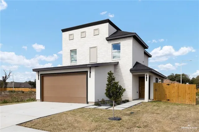 a front view of a house with a yard and garage