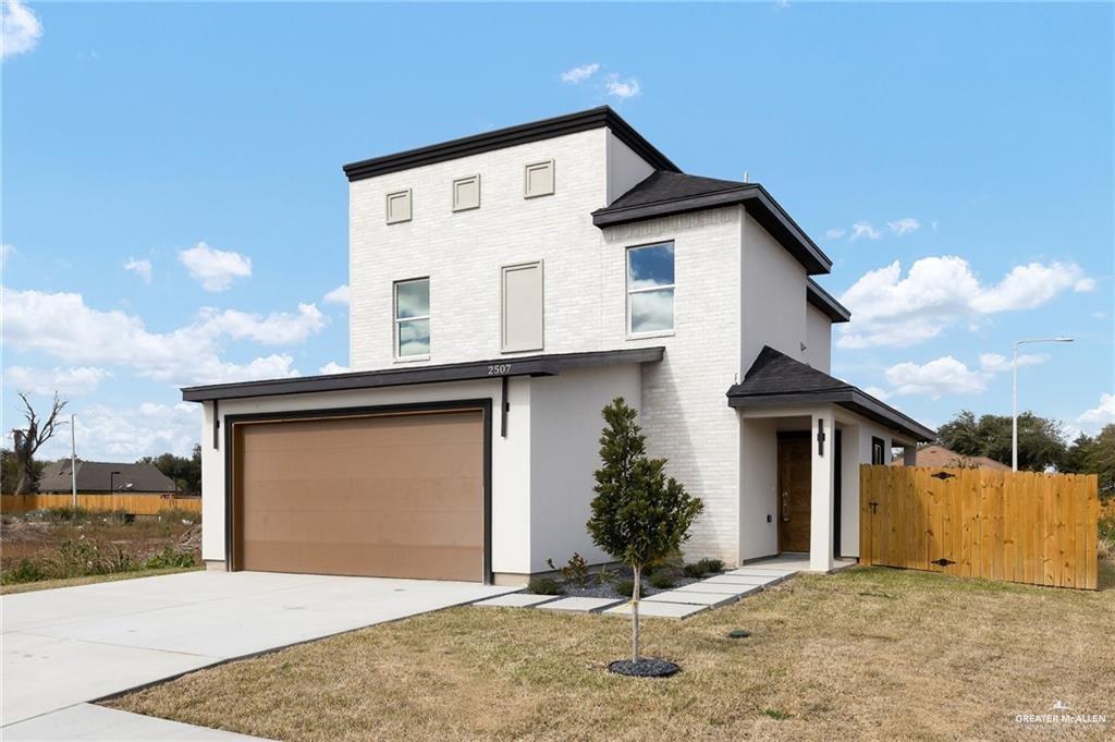2507 Regina Street Mission, TX 78574 - Photo 1 of 16 a front view of a house with a yard and garage