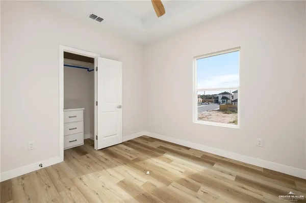 an empty room with a empty space and windows