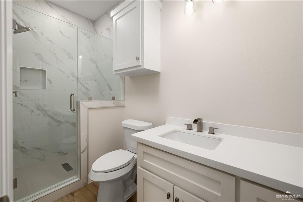 2507 Regina Street Mission, TX 78574 - Photo 12 of 16 a bathroom with a sink a toilet and shower