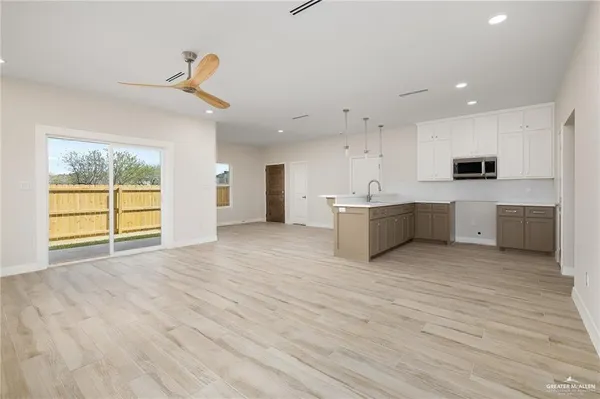 a view of a kitchen with microwave and cabinets