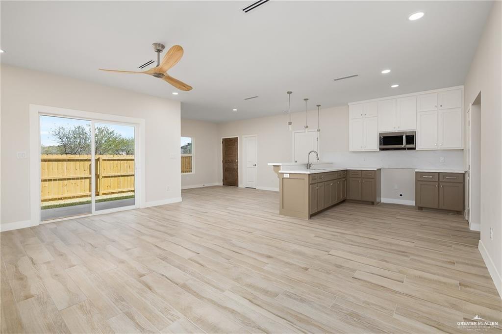 2507 Regina Street Mission, TX 78574 - Photo 3 of 16 a view of a kitchen with microwave and cabinets