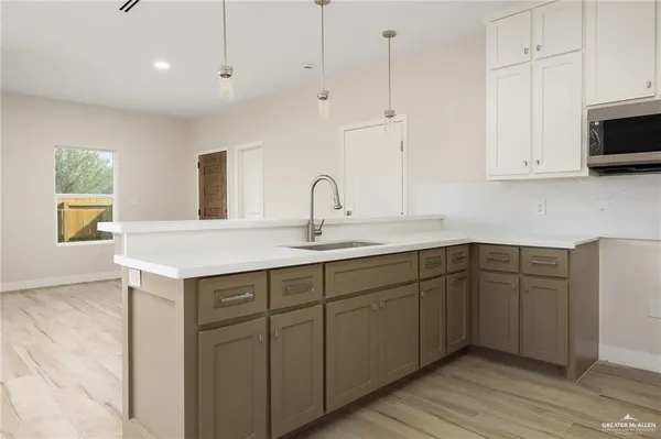 a kitchen with sink and cabinets