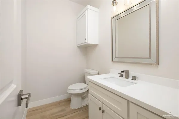 a bathroom with a sink a toilet and vanity