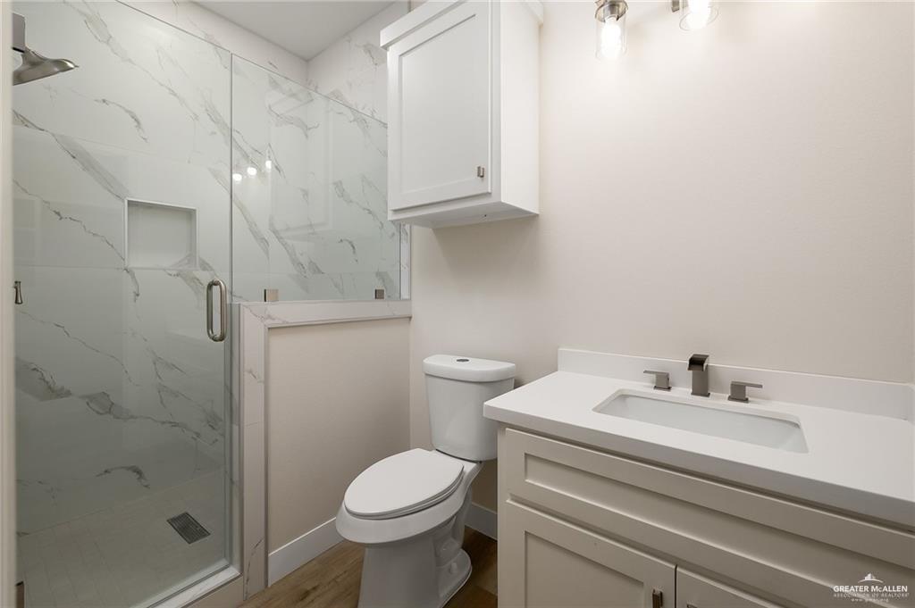 2507 Regina Street Mission, TX 78574 - Photo 9 of 16 a bathroom with a sink a toilet and shower