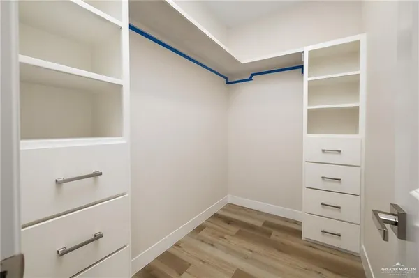 a view of walk in closet with empty racks